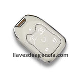 Detalle de funda protectora TPU blanco brillante con iconos dorados para llave de presencia Chevrolet GMC 6 botones acabado espejo premium sofisticada y luminosa